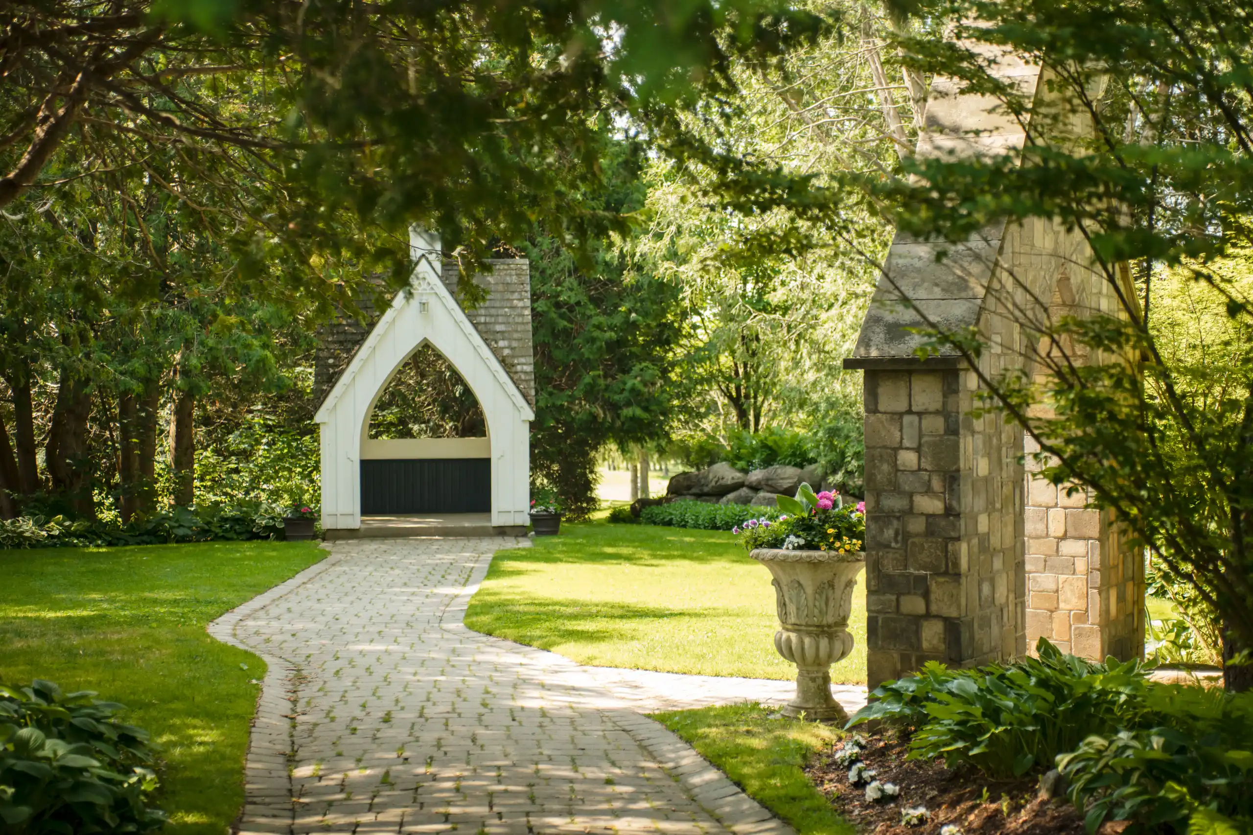 A brick path to the white garden chapel