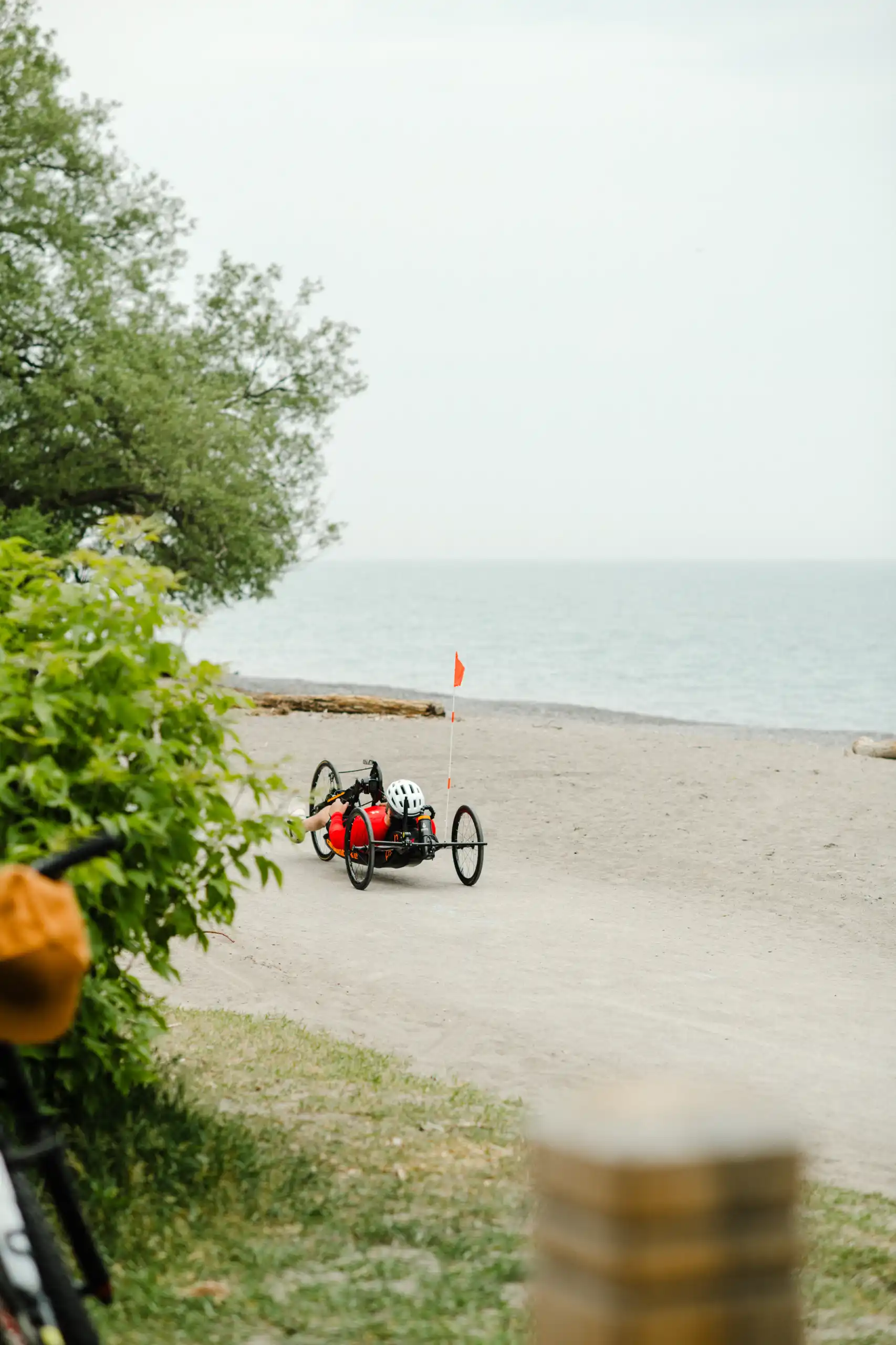 An adaptive athlete handcycling the waterfront trail